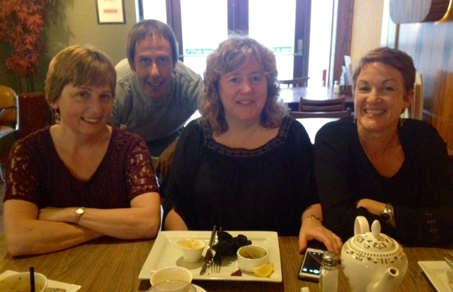 One Voice For Care ensemble musicians pictured around a dining table prior to concert.
